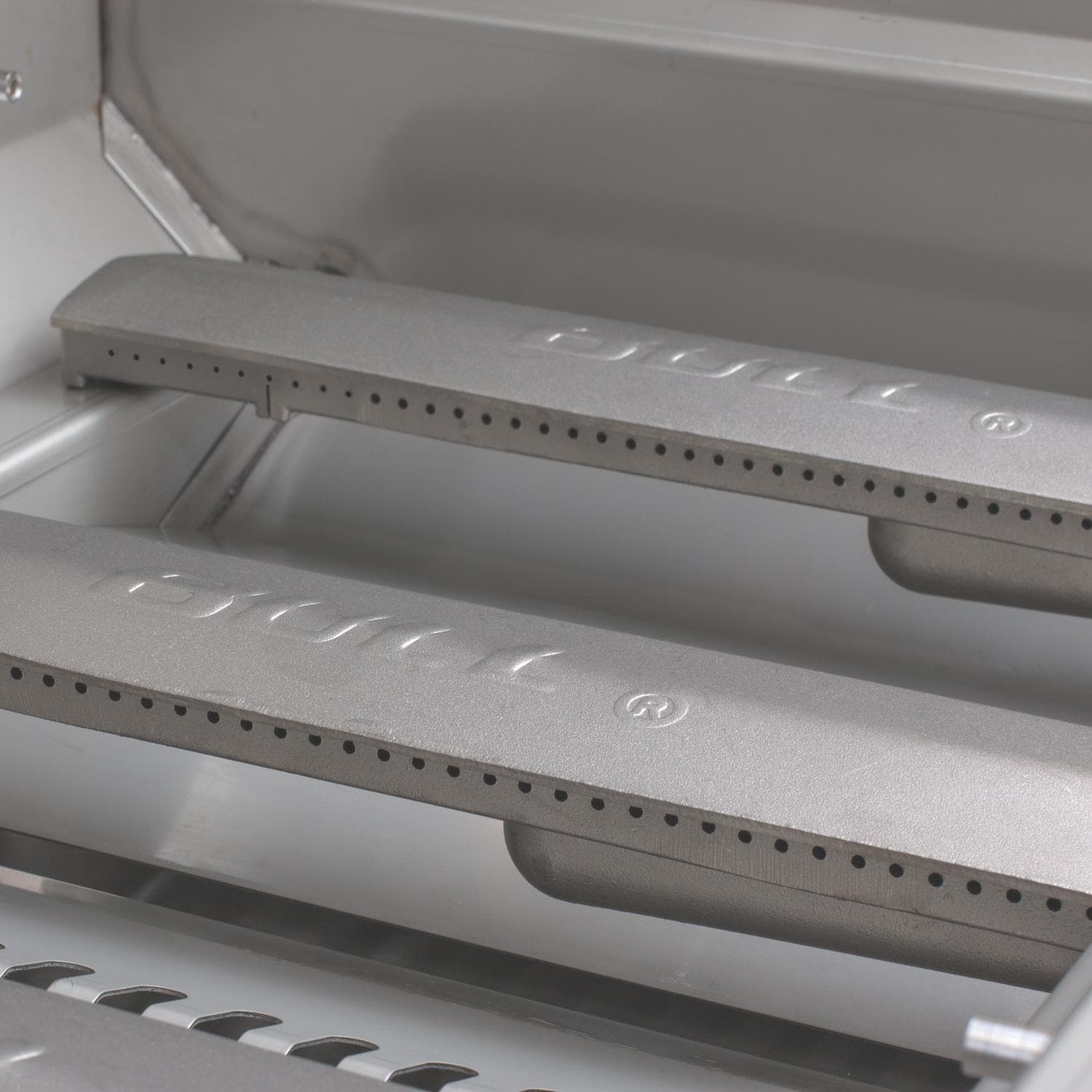 Close-up of grill grates with 'Bull' branding on a metallic surface.