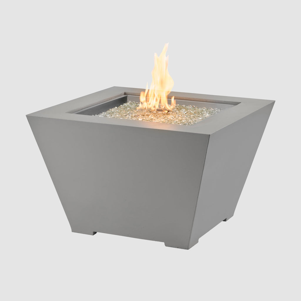 Cove Concrete Trapezoid 37-inch gas fire pit bowl in Natural Grey with lit flame on grey background