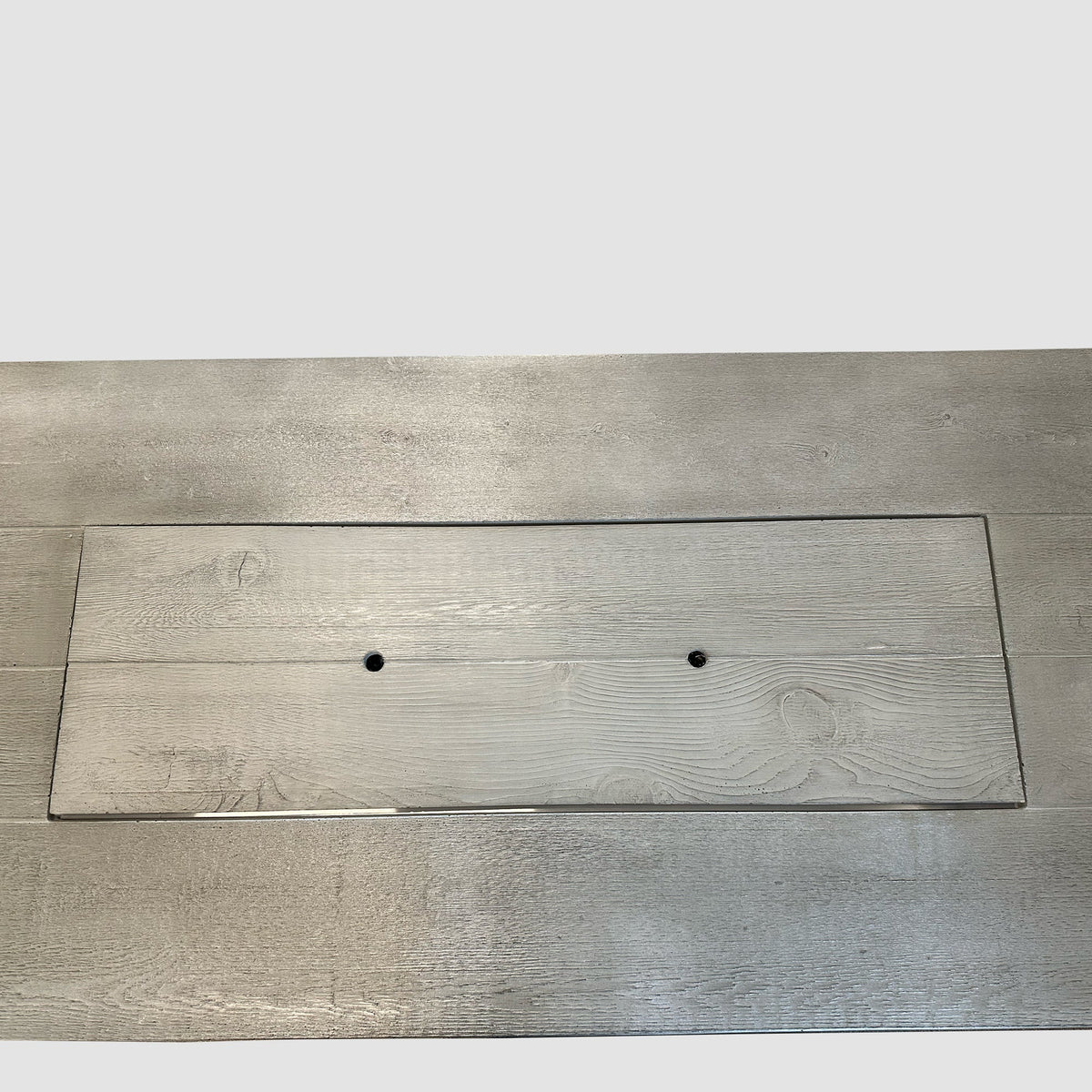 Top-down view of the Cedar Ridge fire pit table with the Supercast burner cover in place